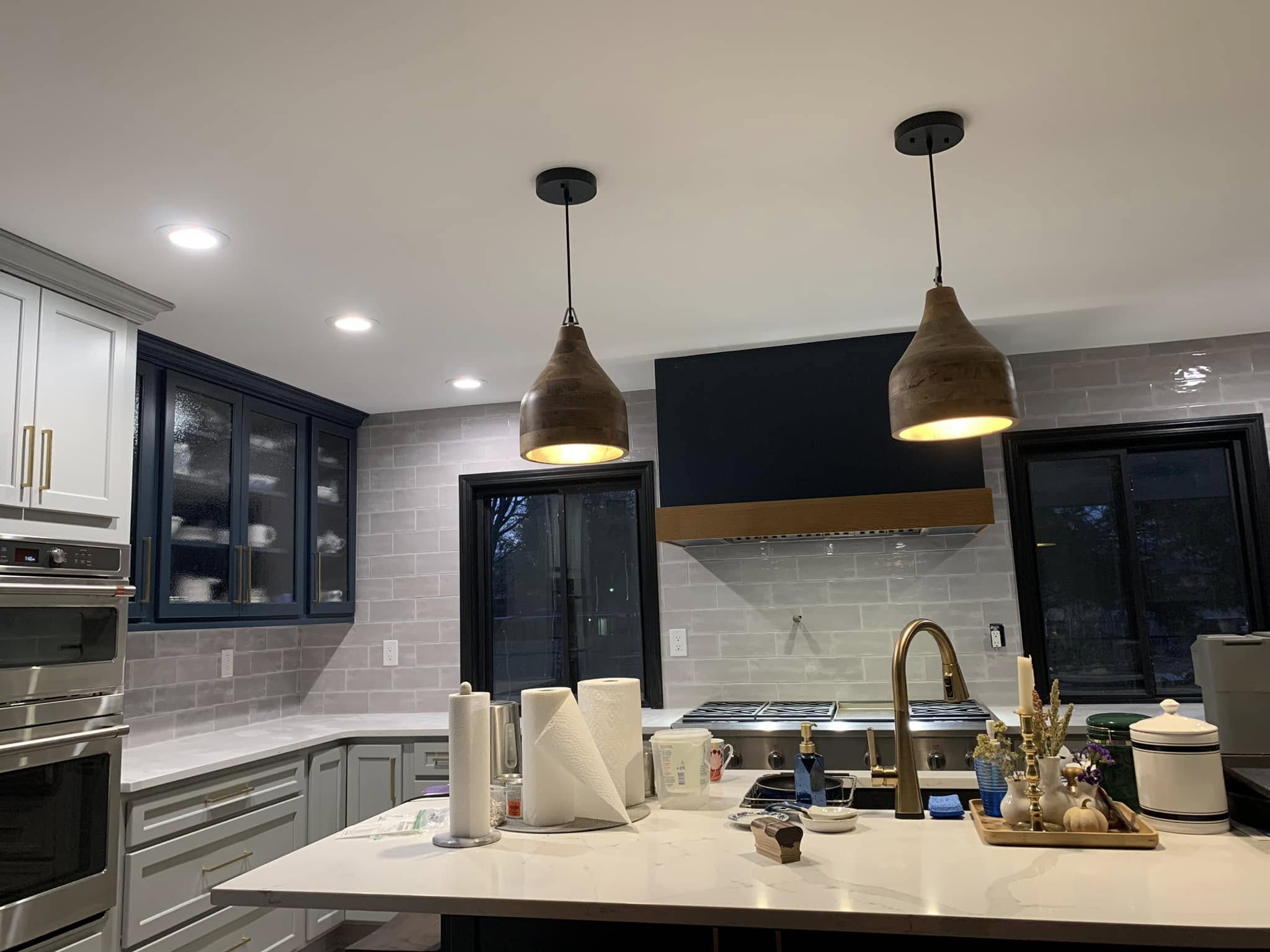 A finished kitchen remodel with new cabinets, counters and a tiled backsplash.
